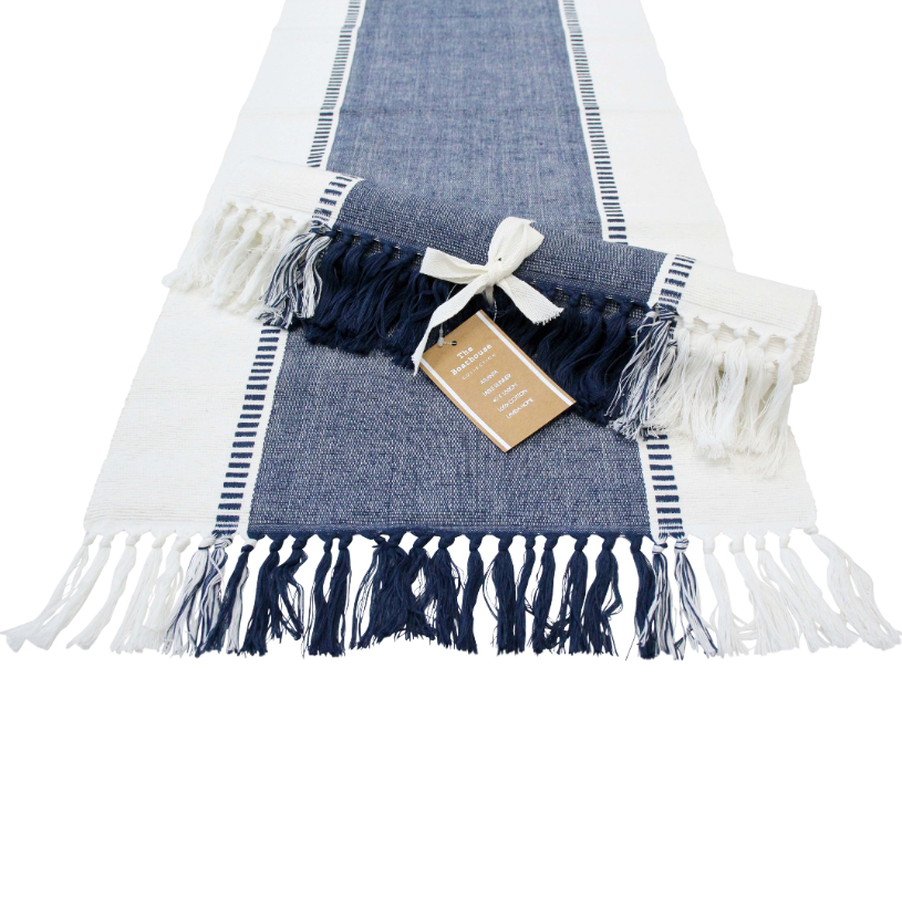 Navy and white chambray table runner with fringe detail laid flat