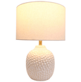 Coastal ceramic table lamp with textured finish styled in a contemporary living room
