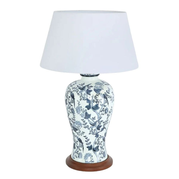 Blue and white ceramic table lamp with bird and floral motif, white shade and timber base