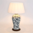 Close-up of hand-painted blue bird and floral design on ceramic lamp base