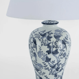 Blue and white table lamp styled on bedside table creating warm ambient lighting
