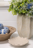 Blue faux baby breath bouquet styled on shelf with coastal home accessories