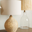 Balle rattan lamp styled on a bedside table in a coastal-inspired bedroom interior