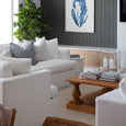 Large reclaimed wood square coffee table styled in a Hamptons-inspired living room.
