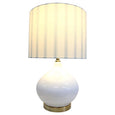 Coastal-inspired Bayville lamp with brushed gold detailing styled on bedside table
