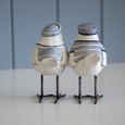 Rear view of Beach Birds Set of 2 showing hand-finished blue and white details, sculpted tails and iron legs.