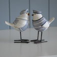 Side view of Beach Birds Set of 2 showing their blue and white sailor outfits, sculpted wings and decorative iron legs.