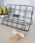 Beechwood citrus reamers styled on a kitchen benchtop beside a cookbook stand