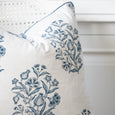 Close-up of the Bellamy Garden Cushion showing its Coastal Blue botanical floral print on white cotton with blue piped edging.