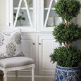 Bellamy Garden Cushion Sage Green styled with white cabinetry and topiary in a Hamptons interior