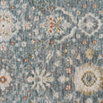 Detailed botanical pattern of the Bellamy Sea Glass Rug in sea glass blue, ivory, olive and soft rust tones.