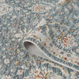 Folded Bellamy Sea Glass Rug showing its finely textured soft polyester pile and detailed floral design.