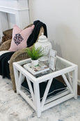 Benedict Glass Top Side Table styled beside a sofa with a table lamp and decorative accessories.
