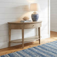 Beresford Curved Console Table styled in a Hamptons entryway with a blue ceramic table lamp, coral décor and a coastal runner.