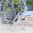 Bird Navy White Set of 3 decorative coastal bird figures styled in front of a blue ceramic pot with baby breath florals
