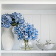 ceramic bird bowl styled on shelf with blue hydrangea arrangement coastal decor