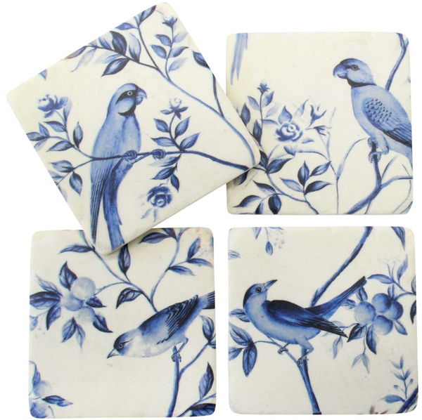 Set of four blue and off-white chinoiserie bird coasters with assorted botanical illustrations