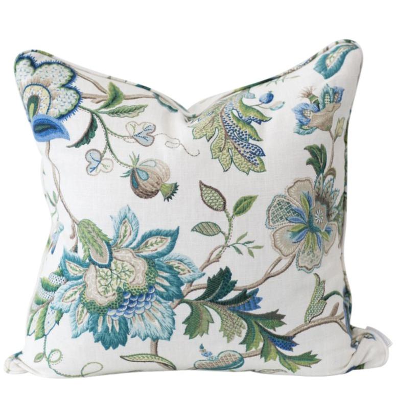 Blue Sapphire floral cushion in soft blue and green tones on a white linen blend background, 50x50cm