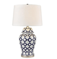 Pair of blue and white ceramic bedside lamps creating a balanced coastal interior look
