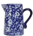 Blue and white ceramic jug with floral pattern and curved handle