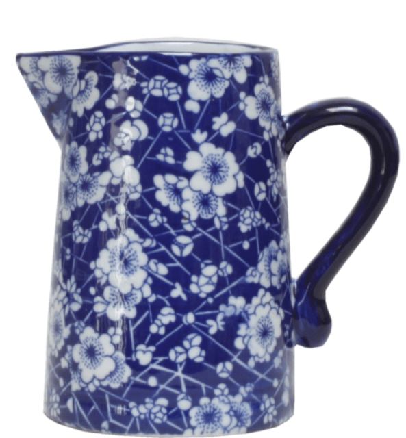 Blue and white ceramic jug with floral pattern and curved handle