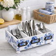 Blue and white cutlery organiser tray styled on a marble kitchen bench with utensils and coastal décor