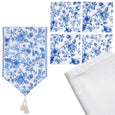 Blue and white dining bundle featuring floral table runner, ceramic coasters and white linen napkins on a neutral background