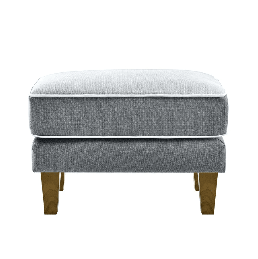 Bondi ottoman in grey fabric with white piping and wooden tapered legs front view