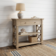 Bridgehampton Weathered Oak Console Table Small styled in a Hamptons entryway with a ceramic lamp, decorative coral, books and woven basket.