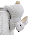 White ceramic bunny pot sitter ornament perched on the edge of a decorative planter
