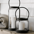 Cabin Lantern Short styled with larger matching lantern and candles on rustic timber surface