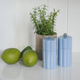 Capri denim wood salt and pepper grinders styled on white kitchen bench with greenery, coastal Hamptons decor