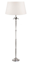 White Casablanca palm tree floor lamp styled in a coastal living room creating a relaxed tropical ambience