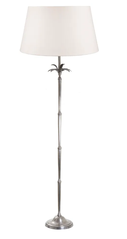 White Casablanca palm tree floor lamp styled in a coastal living room creating a relaxed tropical ambience