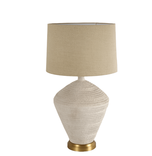 Caufield white sandstone table lamp with linen shade styled on bedside table in coastal bedroom
