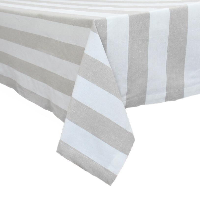 Chambray Natural Stripe cotton tablecloth with neutral coastal stripes draped over dining table