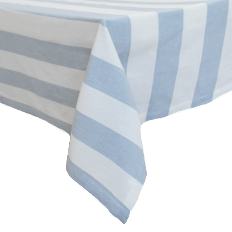 Chambray Stripe Blue Bold Stripe stonewashed cotton tablecloth featuring bold blue and white stripes draped over a dining table.