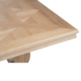 Close-up of geometric oak parquetry tabletop and moulded edge on the Charlotte 240cm dining table.