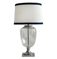 Charlotte glass and nickel table lamp with white linen shade and navy trim on neutral background