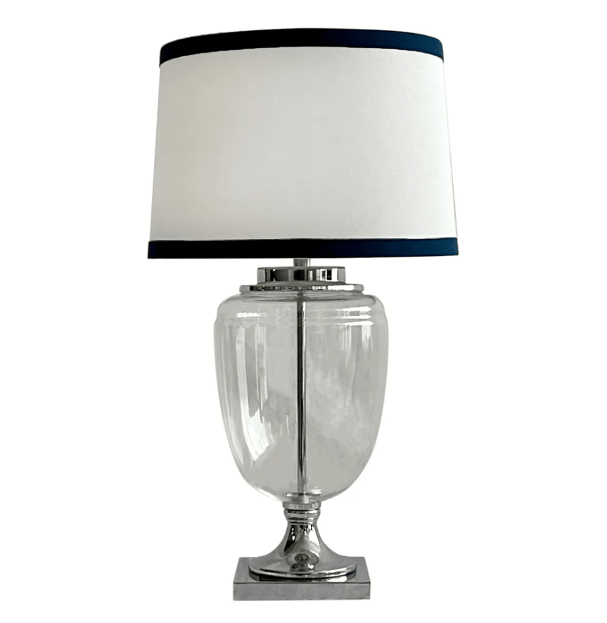 Charlotte glass and nickel table lamp with white linen shade and navy trim on neutral background