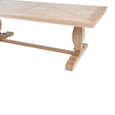 Detail of Charlotte Natural Oak dining table showing parquetry tabletop, moulded edge and trestle-style base.