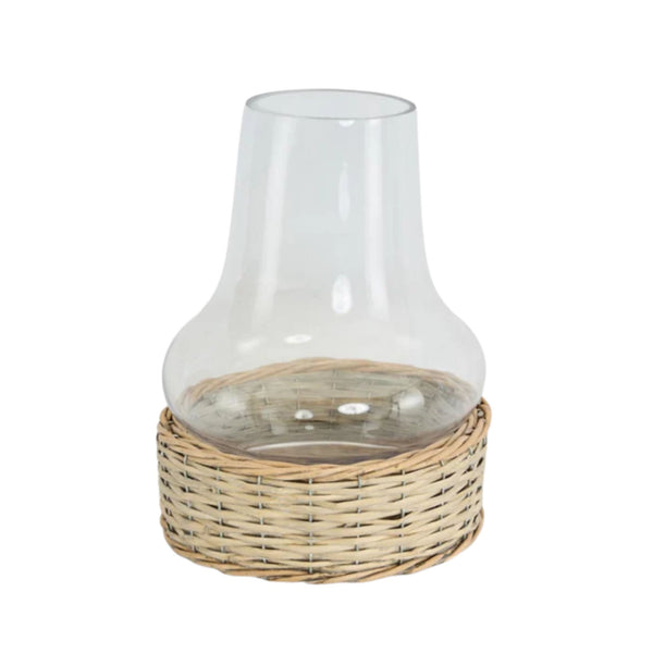 Clear glass chimney hurricane lantern with woven wicker base for coastal home styling