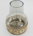 Top angled view of glass chimney hurricane lantern with woven wicker base