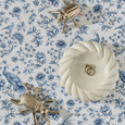 Blue and white Chinoiserie scented drawer liner with floral and bird pattern styled with decorative accessories