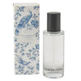 Chinoiserie French Linen scented linen spray in clear bottle with black cap beside blue and white floral patterned gift box.