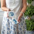 Blue and white Coastal Coasters Set of 4 featuring nautilus and seahorse designs styled in a Hamptons interior.