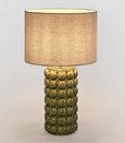Condetti green bedside table lamp with soft ambient lighting in a Hamptons style bedroom

