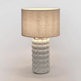 Condetti table lamp with natural linen shade providing soft ambient lighting in a coastal interior