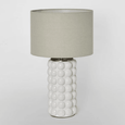 Condetti white table lamp styled on a bedside table in a relaxed bedroom setting
