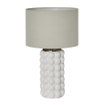 Condetti white ceramic table lamp with raised spherical detailing and natural linen shade on a side table